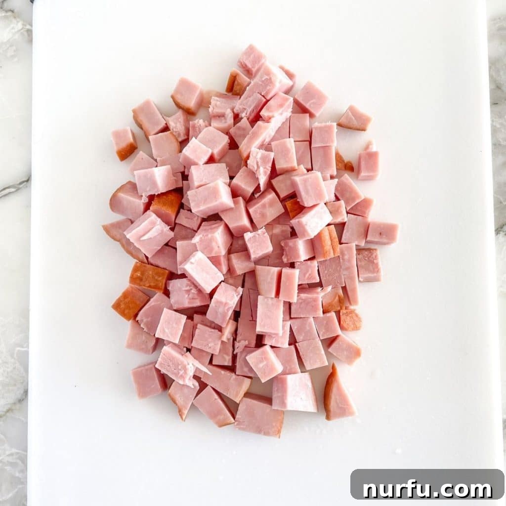 Ham Freezing Demystified: Store, Thaw, and Reheat Safely 4 Diced ham pieces neatly arranged on a wooden cutting board, ready for use.