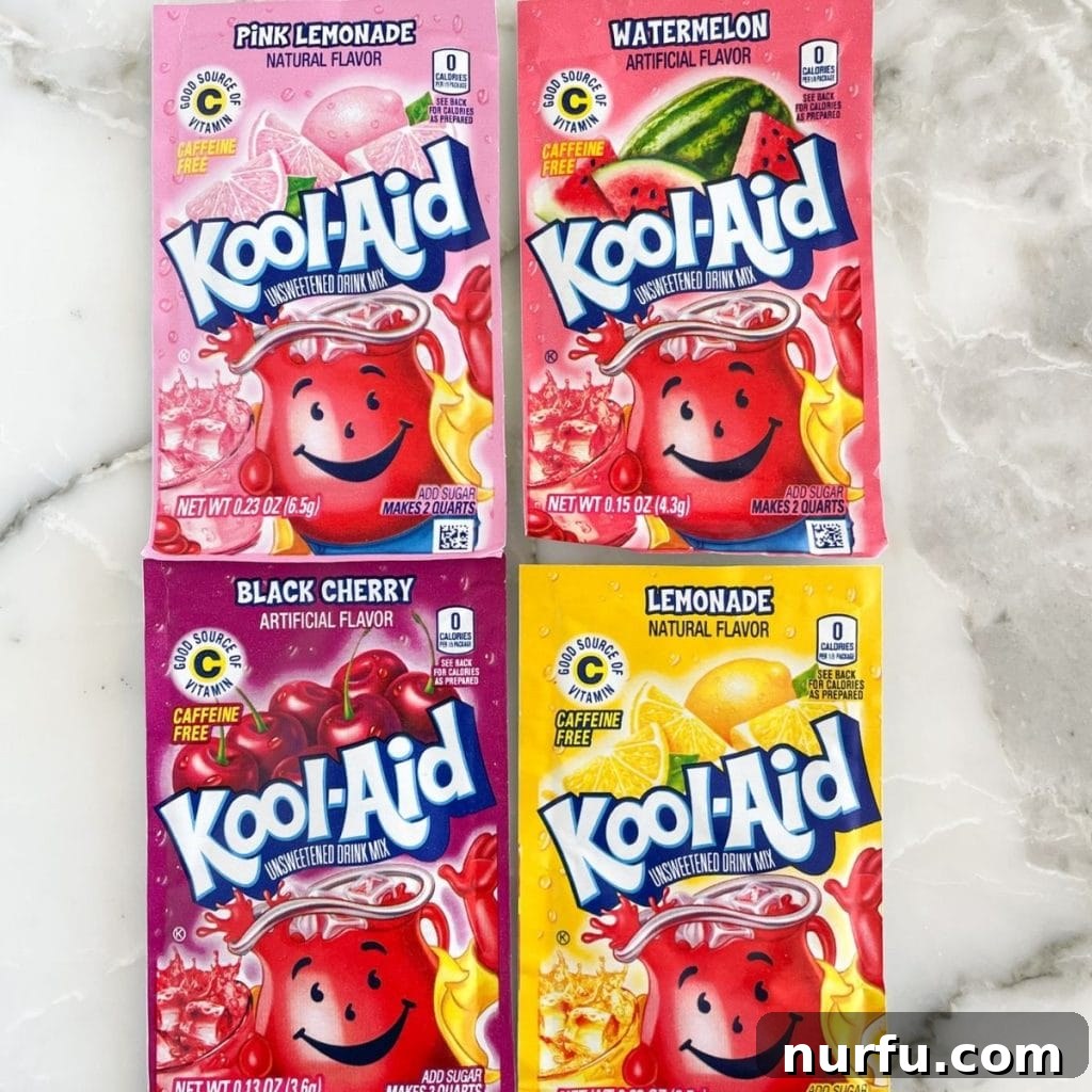 An array of Kool-Aid packets including Pink Lemonade, Watermelon, Black Cherry, and Lemonade, showcasing diverse sweet and tart options.