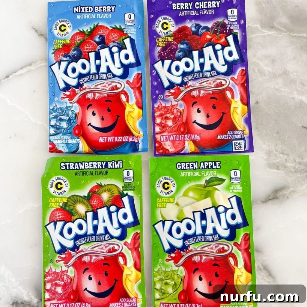A collection of Kool-Aid powder packets showcasing Mixed Berry, Wild Cherry (Berry Cherry), Strawberry Kiwi, and Green Apple flavors.