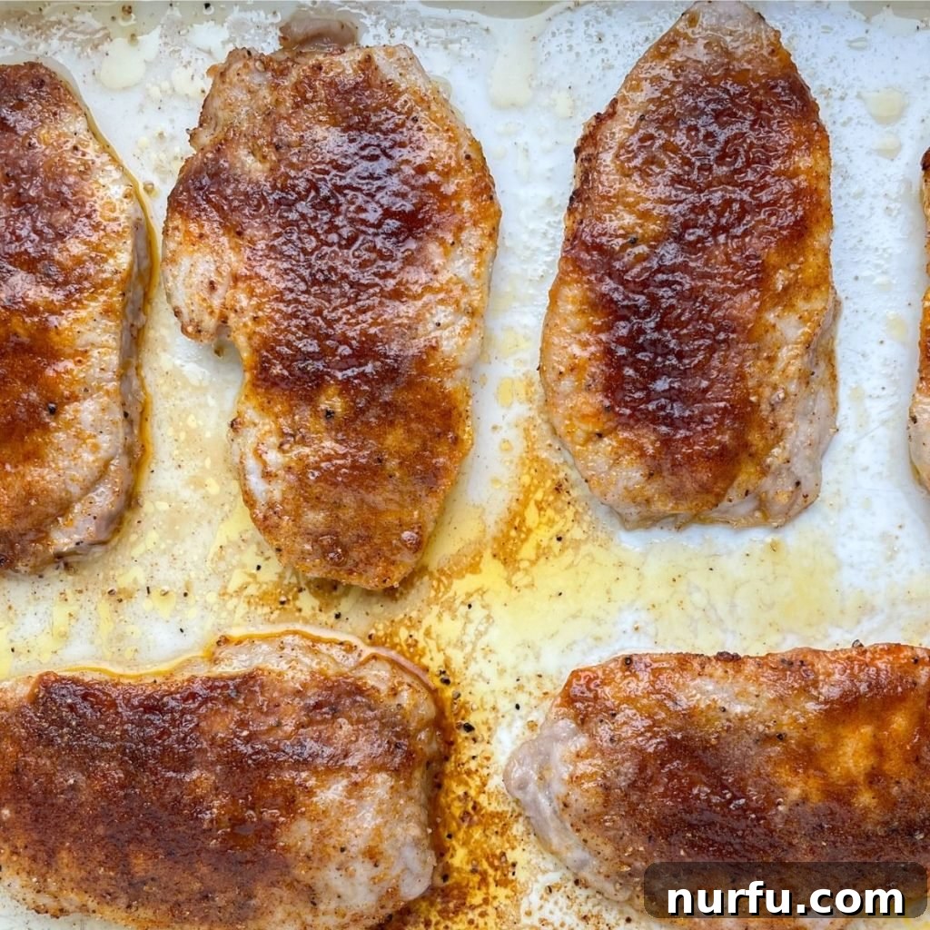 Quick Bake Pork Chops 375 Degrees Perfect Time 4 Freshly baked pork chops arranged neatly in a glass baking dish, golden brown and ready to serve.