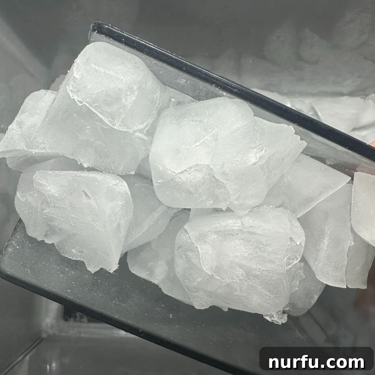Water's Freezing Journey Uncovered 2 Scoop of perfectly frozen ice cubes, ready for refreshing drinks.