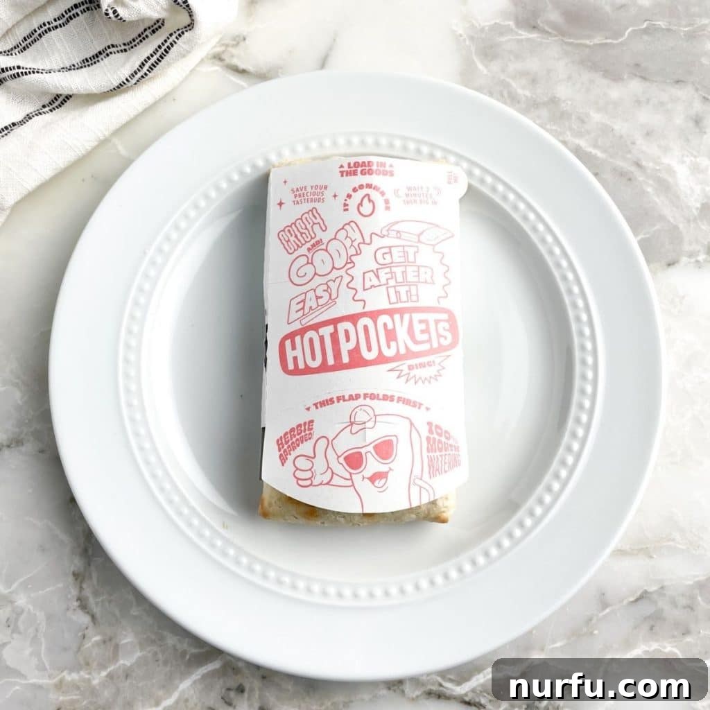 Perfect Hot Pockets Microwave Cook Time 3 A Hot Pocket securely nestled in its crisping sleeve on a pristine white plate, prepared for microwave cooking.