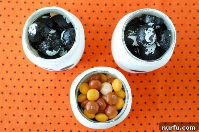 Ghostly Goodie Jar 4 Multiple ghost mason jars filled to the brim with colorful Halloween candies.