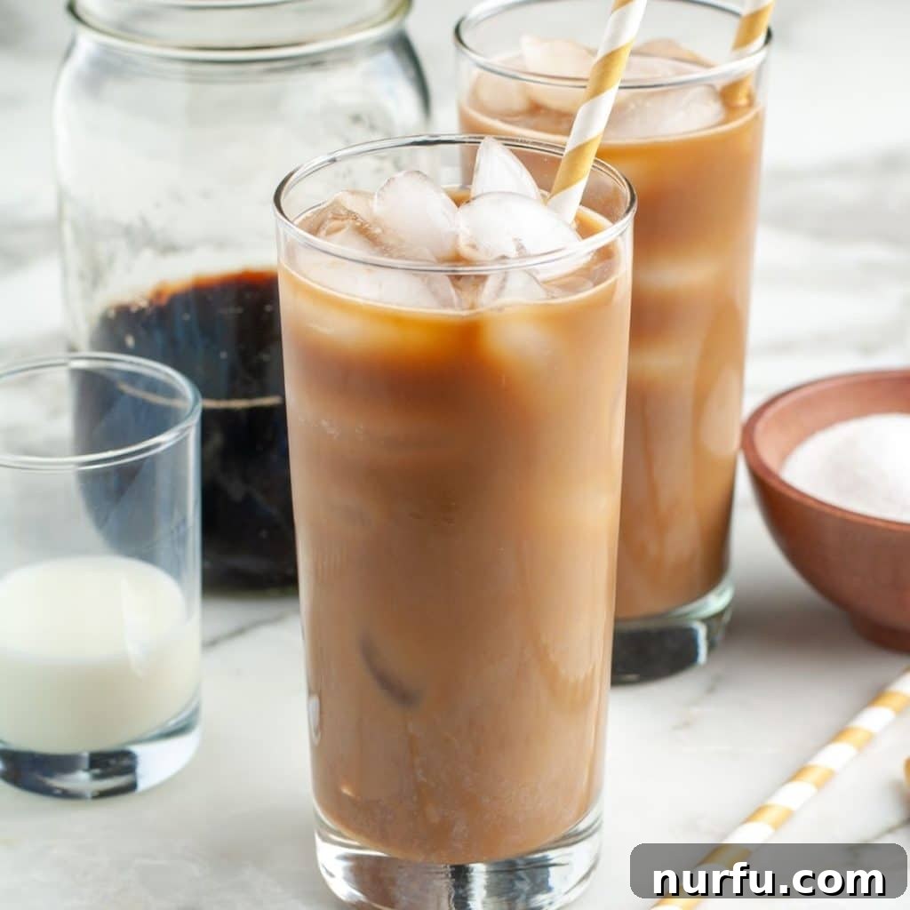 Crafting Perfect Iced Coffee at Home 2 A tall glass of homemade iced coffee with ice and cream, perfectly chilled and ready to drink.