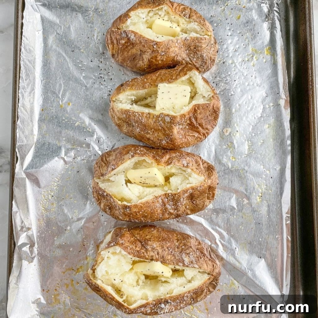 Optimal Potato Bake Time at 400 6 Cooked baked potatoes on a baking pan.