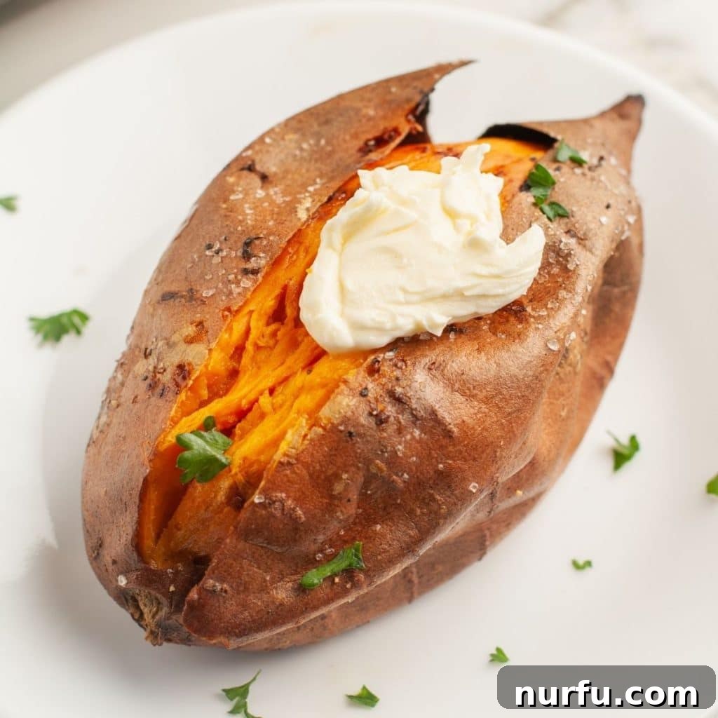 Mastering 400 Degree Sweet Potatoes Bake Time Revealed 6 A single baked sweet potato served on a white plate, sliced open and ready for toppings.