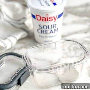 Container of sour cream and a clear container for freezing.