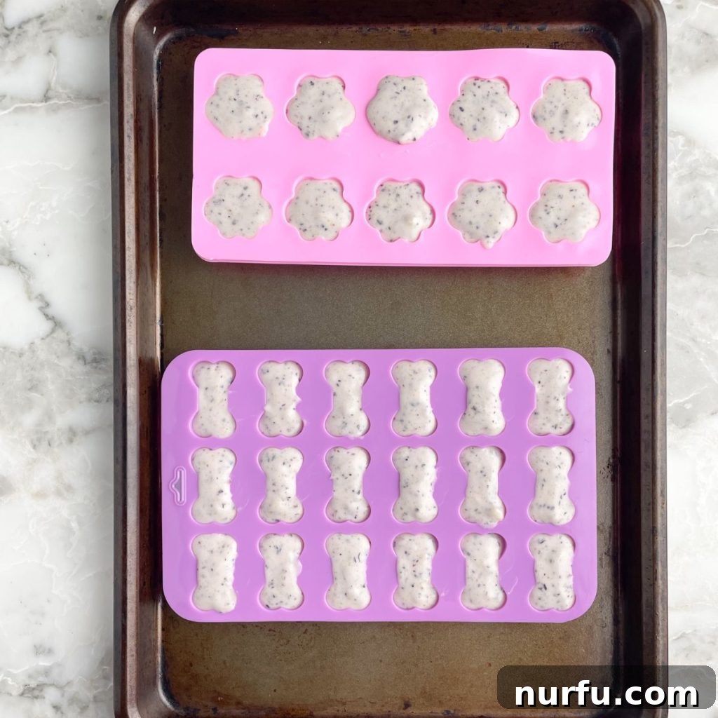 Pupsicles 6 Filled silicone molds on a baking sheet.