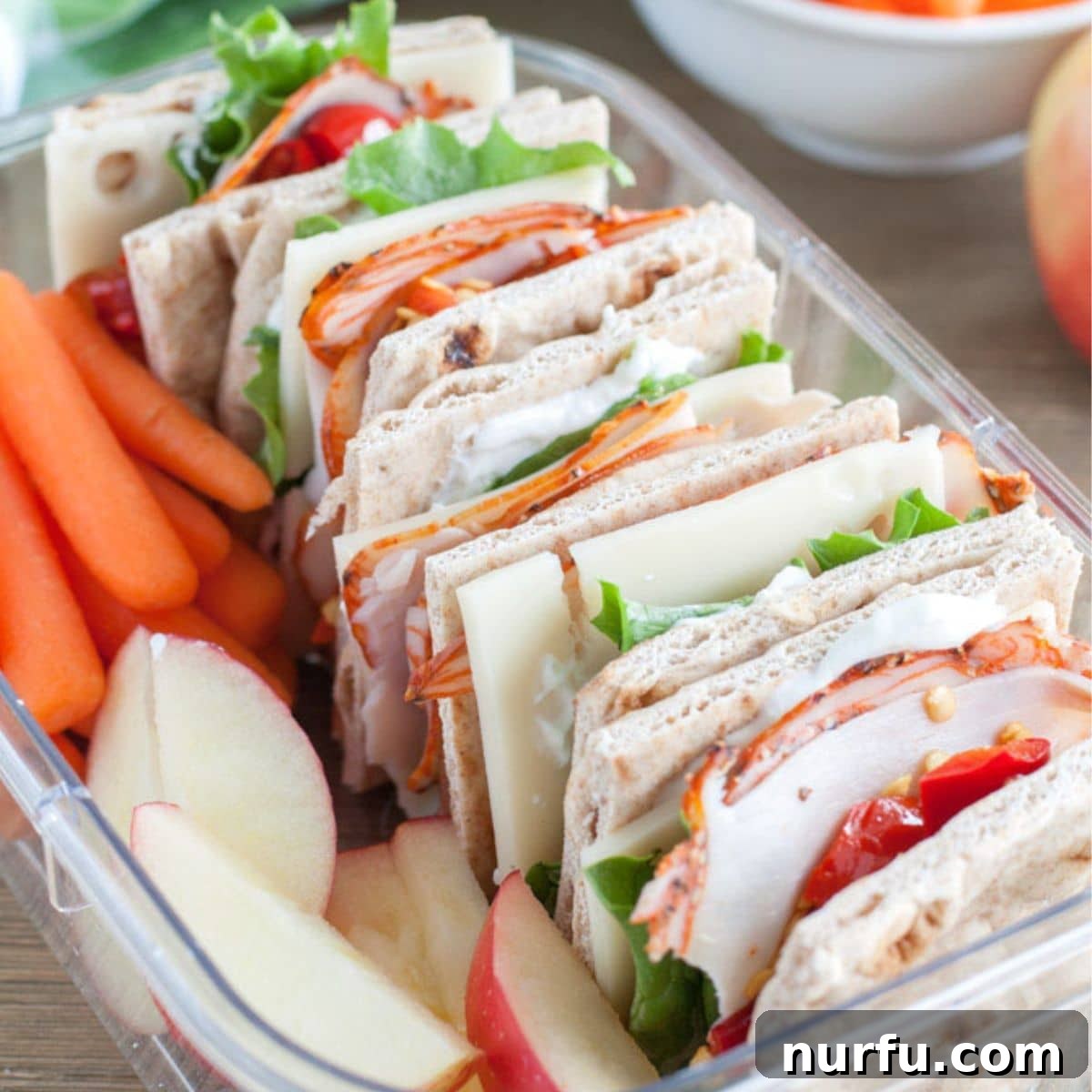 50 Refreshing Cold Lunch Ideas 6 Copycat Starbucks turkey protein box with a small sandwich, apple slices, and carrot sticks, perfect for a balanced cold lunch.