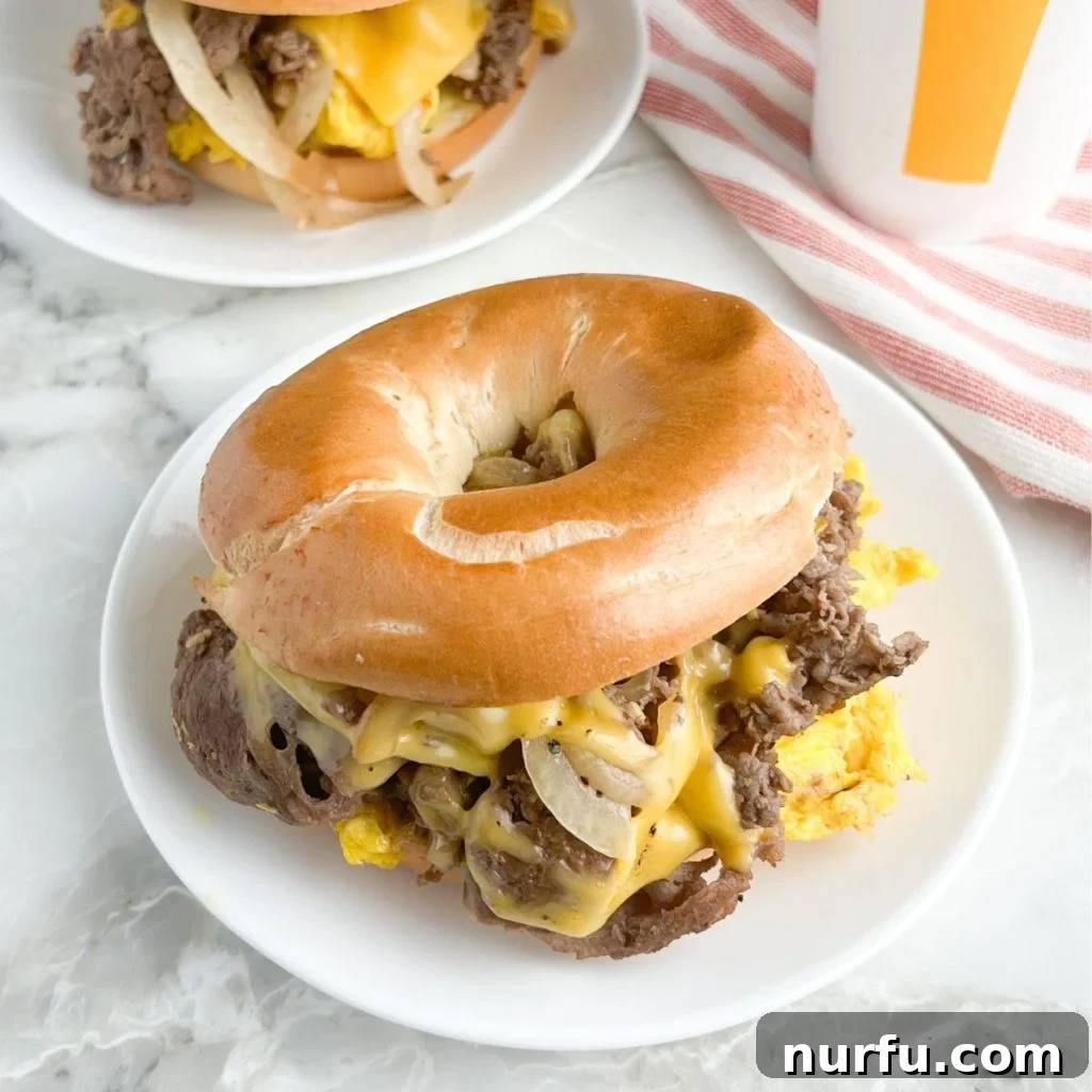 Homemade McDonald's Steak Egg And Cheese Bagel 8 A completed homemade Steak, Egg & Cheese Bagel sandwich, with all layers visible and ready to eat.