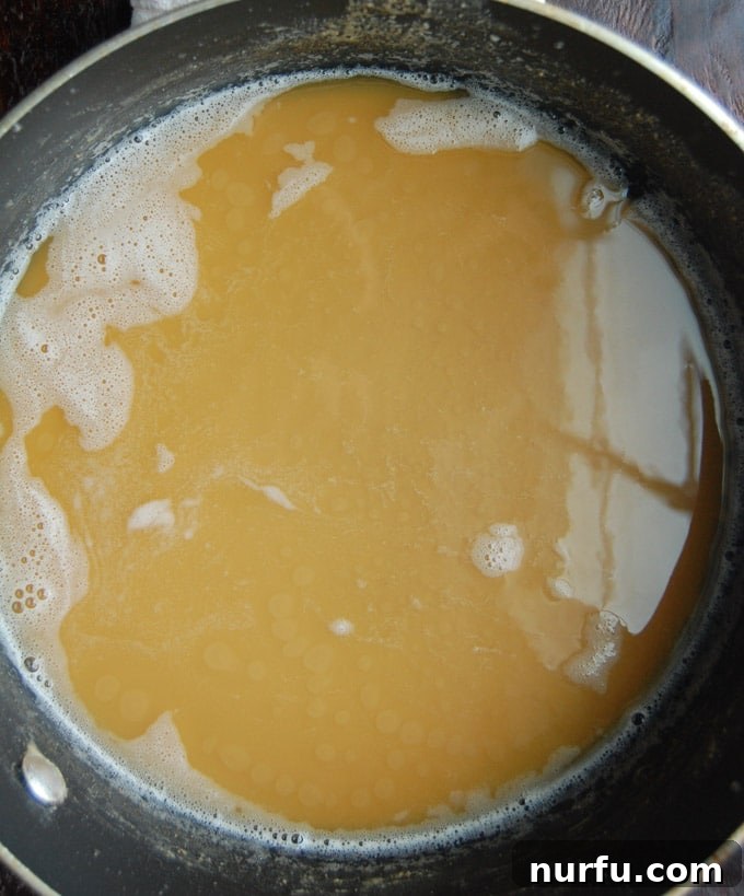 Perfectly Browned Roux A golden-brown roux simmering in a saucepan, showcasing the perfect peanut butter color for a delicious Etouffee base.
