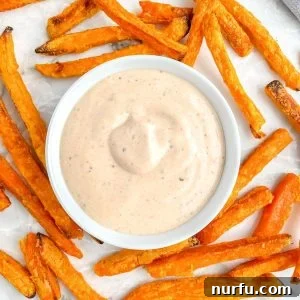 Sweet Potato Fry Dipping Bliss 5 Sweet potato fries and bowl of creamy dipping sauce on a wooden board.
