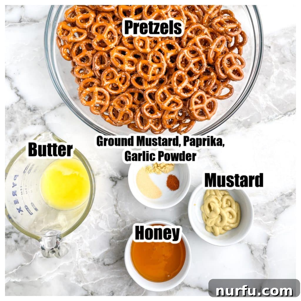 Zesty Honey Mustard Pretzel Bites 3 A collection of ingredients for honey mustard pretzels, including a bowl of pretzels, melted butter, honey, Dijon mustard, and various spices.