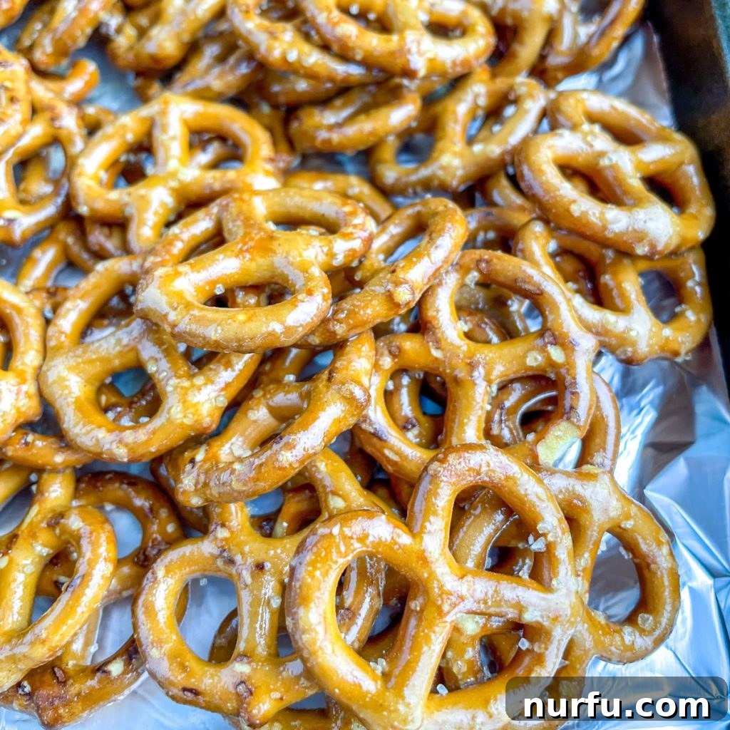 Zesty Honey Mustard Pretzel Bites 4 Coated mini pretzels spread out on a baking sheet, ready for baking.