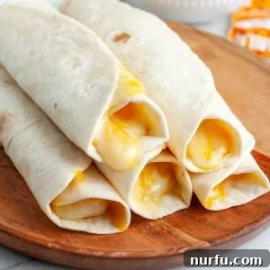 A plate of perfectly rolled up tortillas filled with melted cheese, ready to be enjoyed.