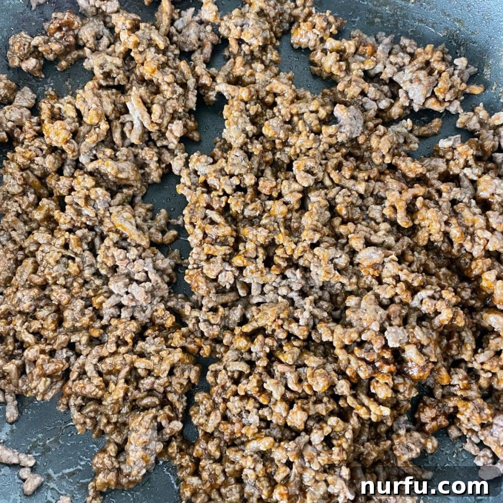 Ultimate Homemade Cheesy Gordita Crunch 4 Cooked ground meat in a skillet.