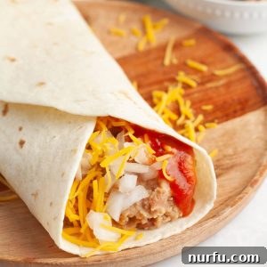 Bean burrito on wooden plate.