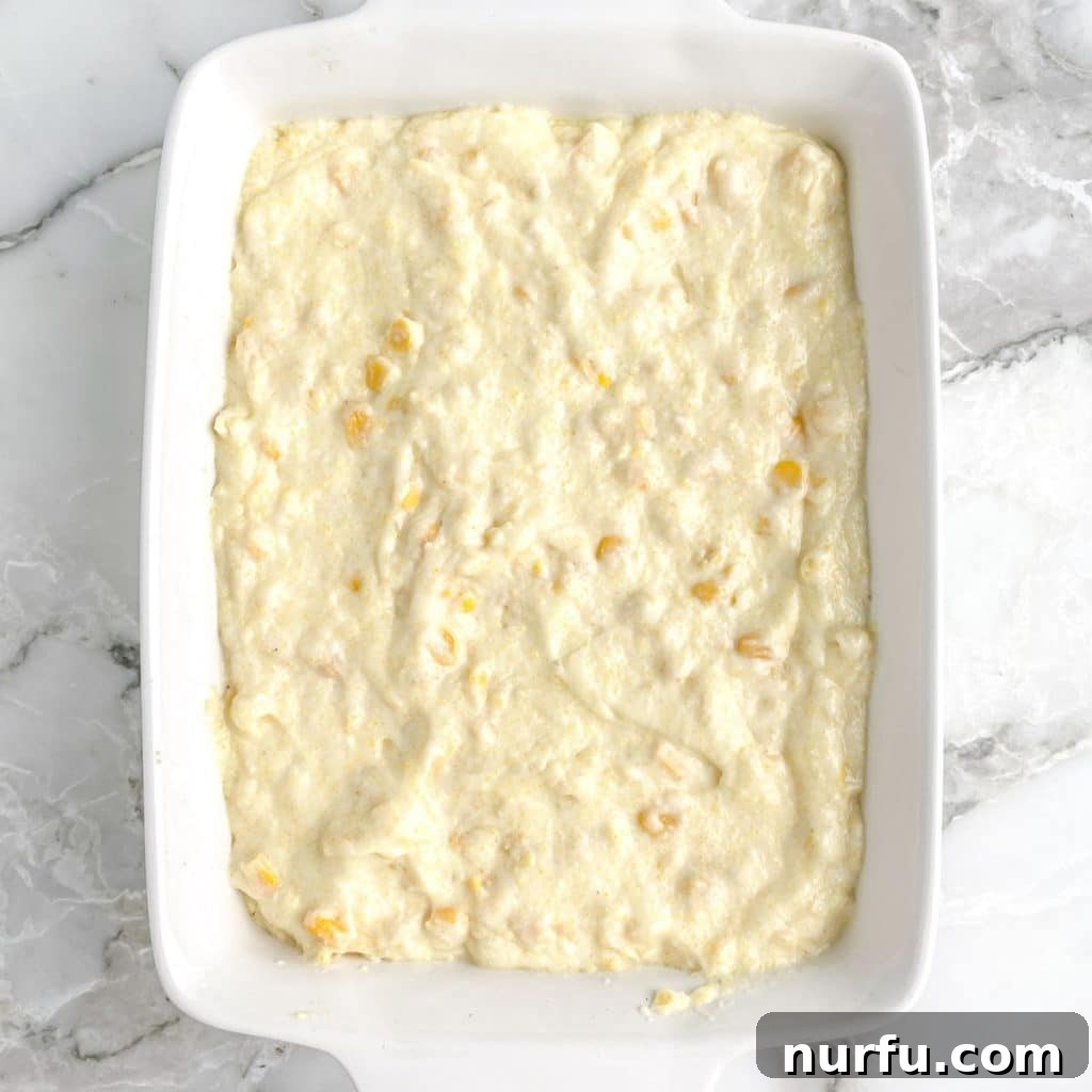 Jiffy Sweet Corn Bake 5 A baking dish filled with the corn pudding mixture, ready to be placed in the oven for baking.