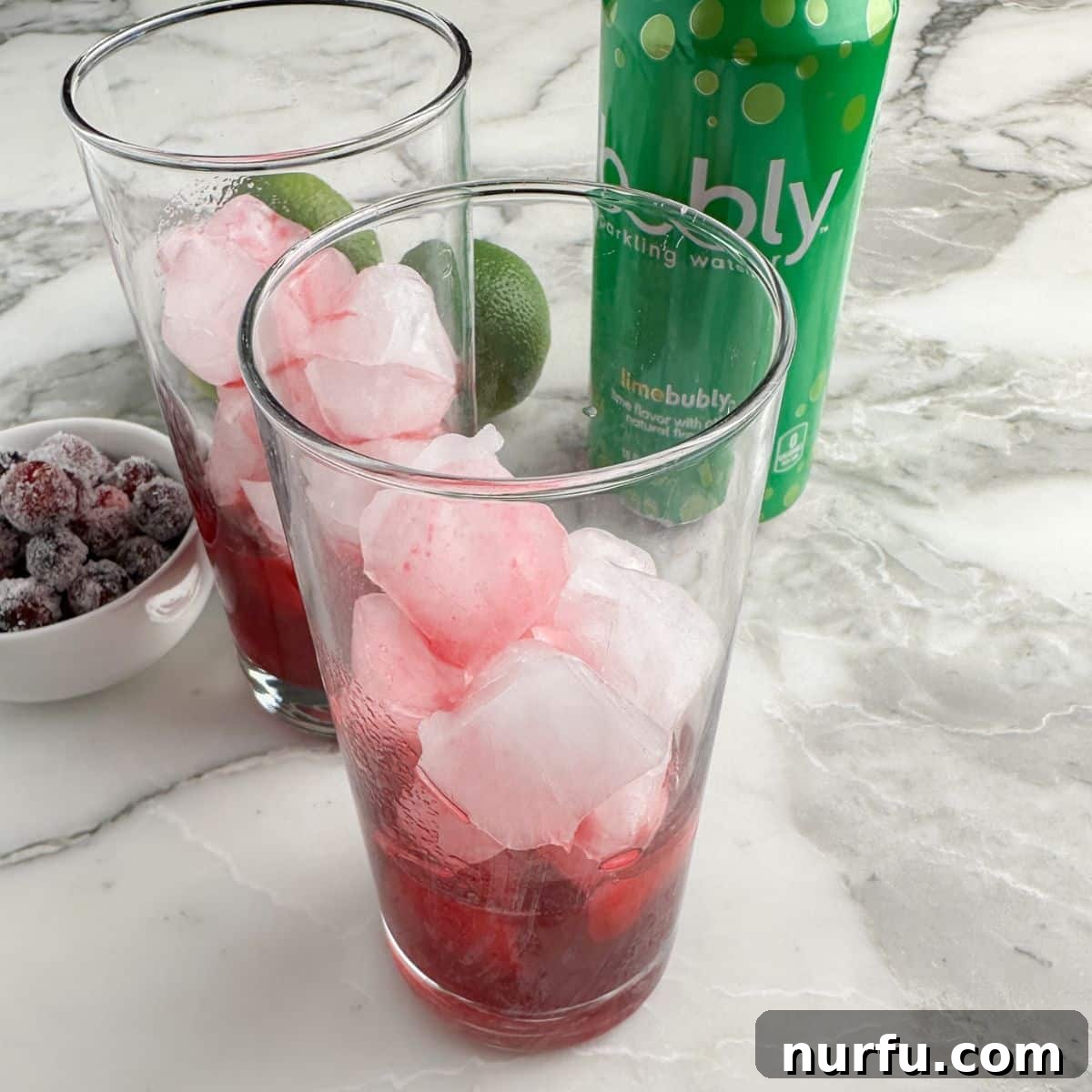 Crimson Citrus Sparkle 6 Glass with ice and cranberry simple syrup.