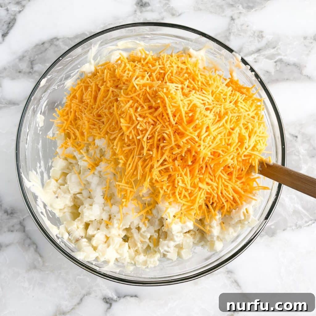 Flavorful Fiesta Spuds 5 Bowl with hash browns and shredded cheese.