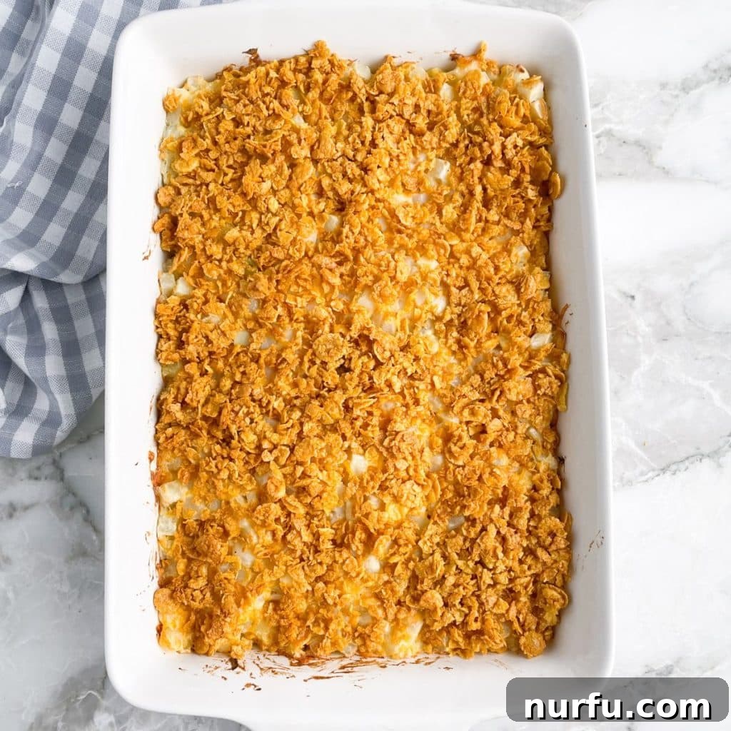 Flavorful Fiesta Spuds 6 Casserole dish with potato casserole topped with corn flakes.