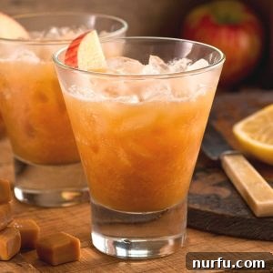 Sip the Season: Delightful Apple Cider Cocktail Recipes 3 Glass filled with ice and apple juice.