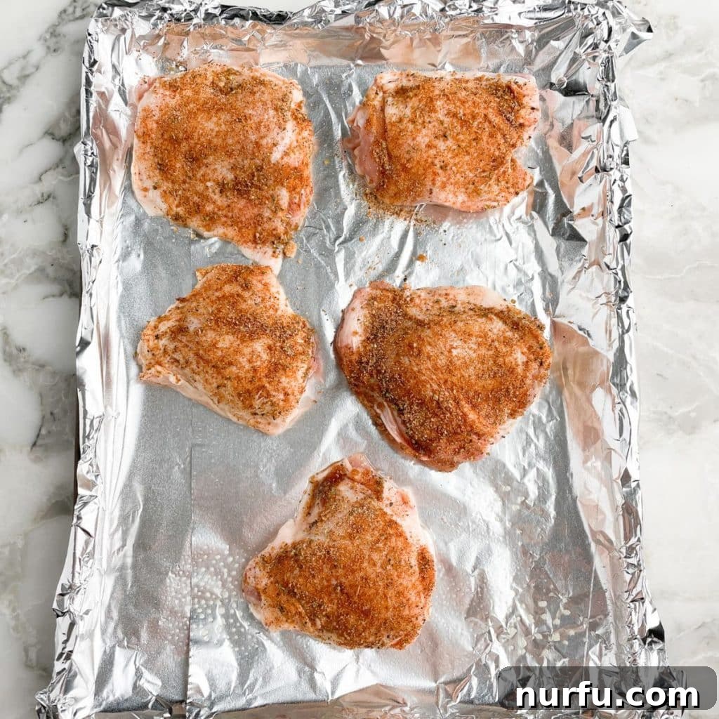 Get Juiciest Chicken Thighs The 350 Degree Bake Time Revealed 6 Seasoned chicken thighs arranged skin-side up on a baking sheet.