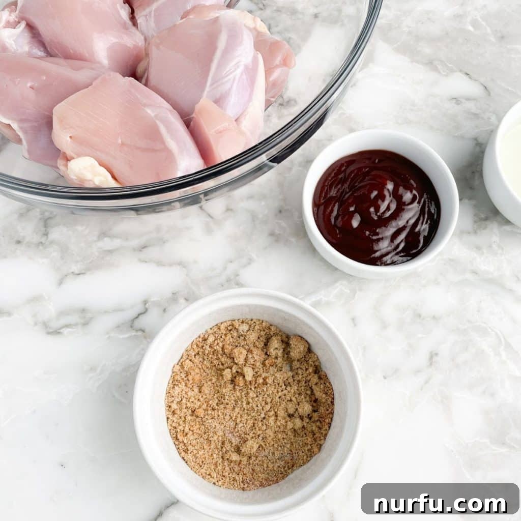 Sticky BBQ Chicken Thighs 4 Raw chicken thighs in a bowl next to a dish of seasoning and a bottle of BBQ sauce, ready for preparation.