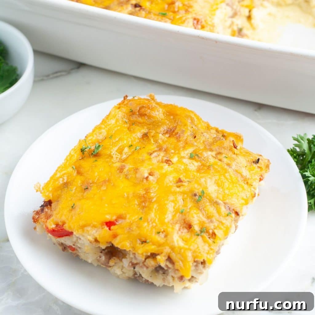 Golden Bisquick Breakfast Delight 8 A perfectly portioned slice of easy Bisquick breakfast casserole on a white plate, ready to be enjoyed as a meal.