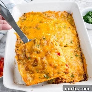 Golden Bisquick Breakfast Delight 9 Slice of breakfast casserole on a serving spoon.