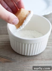 Eggnog Cookie Cups A pair of sugar cookie cups, freshly baked and still cooling in a mini muffin pan, ready to be filled with eggnog pudding for a delightful holiday treat.