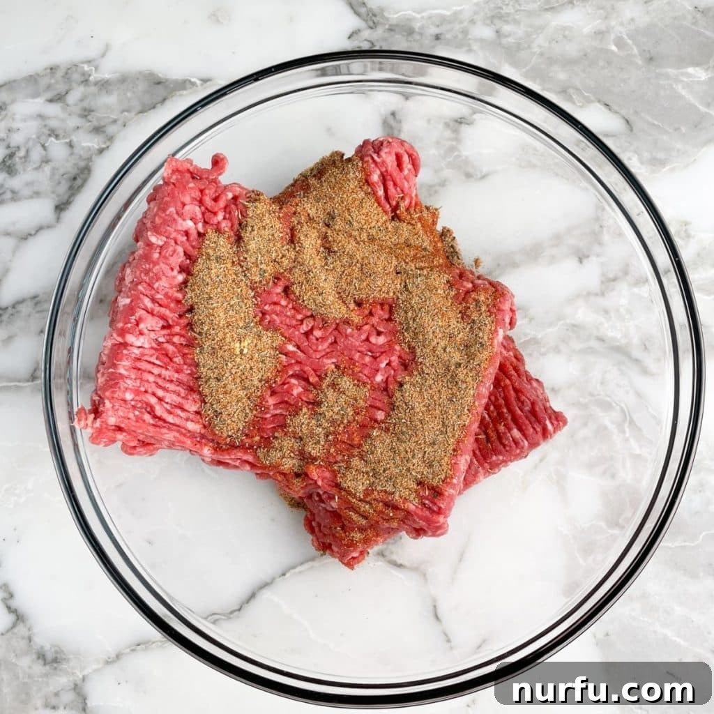 Homemade Meatloaf Spice Blend 4 Ground beef mixed with seasoning in a bowl, ready for shaping.