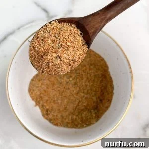 Homemade Meatloaf Spice Blend 6 Bowl and spoon with a perfectly blended meatloaf seasoning mix.