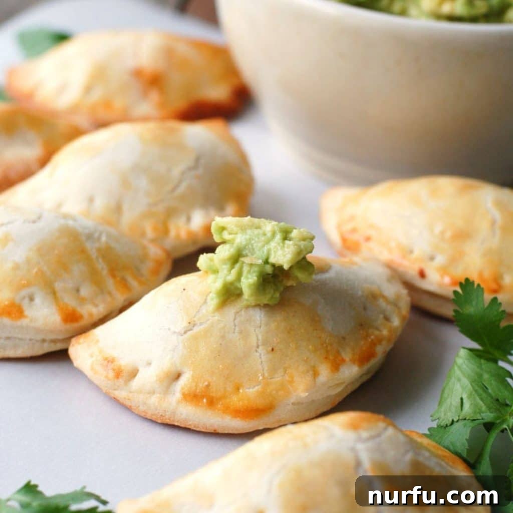 Empanadas served with a side of creamy guacamole, highlighting their versatility as an appetizer.