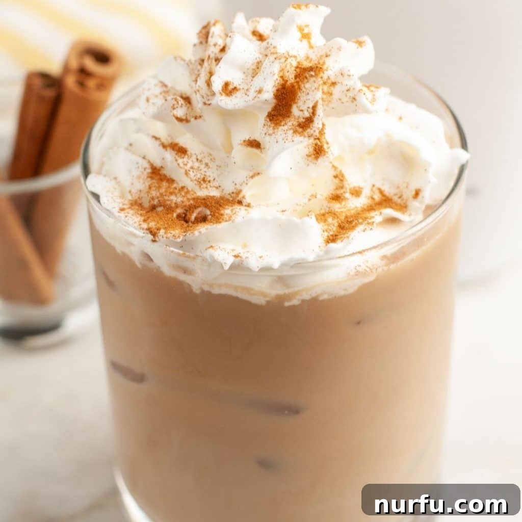 A glass filled with coffee and topped with a generous swirl of whipped cream, suggesting a boozy coffee creation perfect for a relaxed morning.