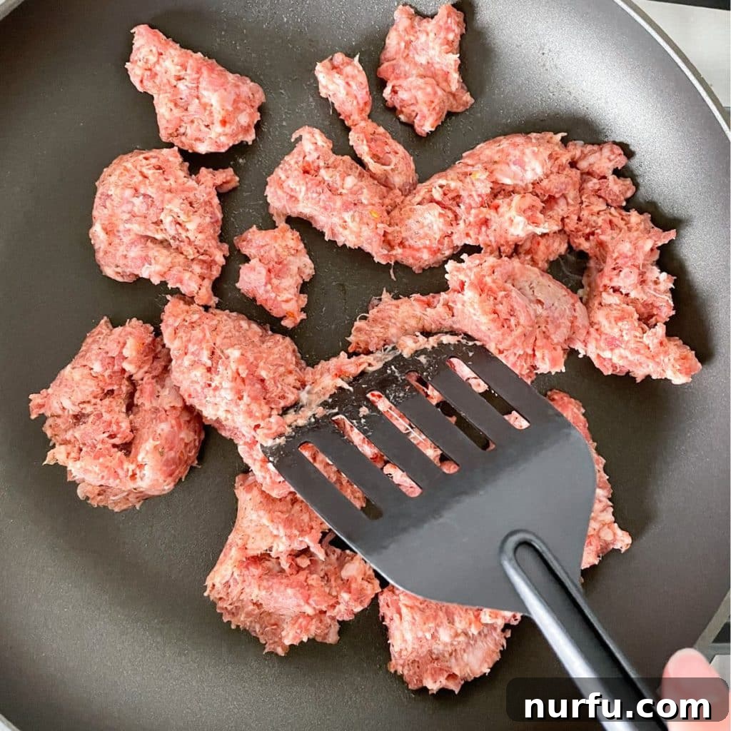 Creamy Velveeta Sausage Dip 4 Sausage in a skillet.