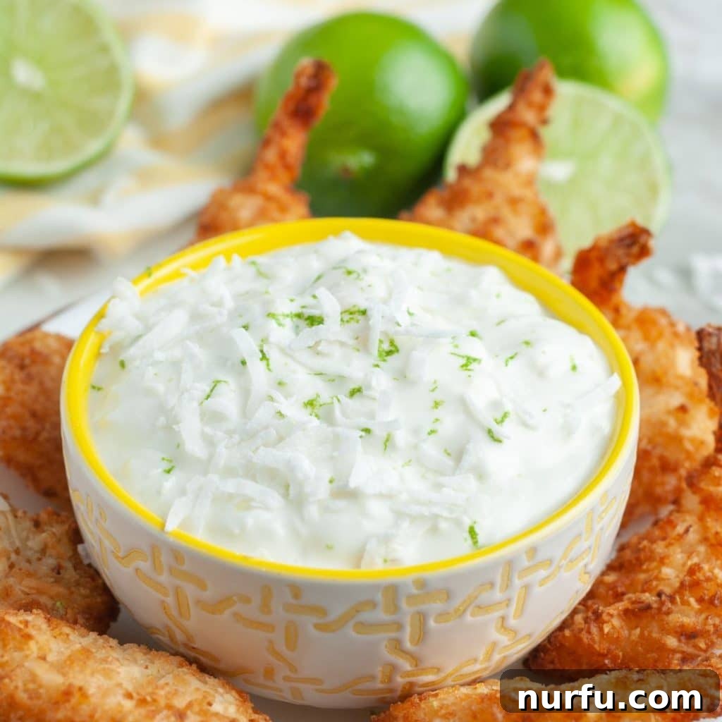 Bowl of white sauce and coconut shrimp.