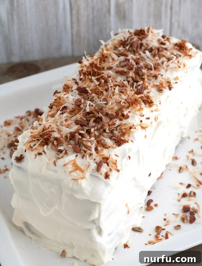 Exotic Coconut Spice Delight 2 A beautifully layered coconut spice cake topped with toasted coconut, ready to be served.