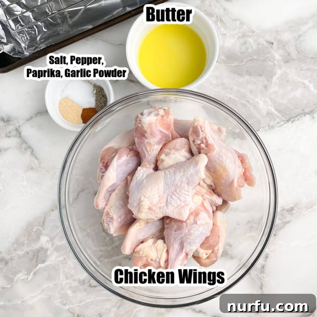 Three bowls displayed: one with uncooked chicken wings, another with melted unsalted butter, and the third with a blend of savory seasonings.