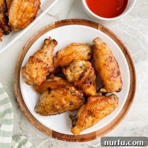 Plate of chicken wings and bowl of sauce.