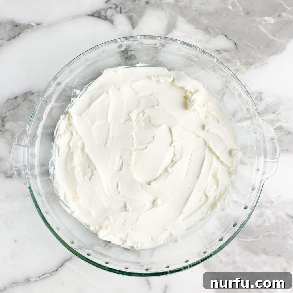 Spicy Cheese Dream 4 Pie dish with cream cheese spread on the bottom.