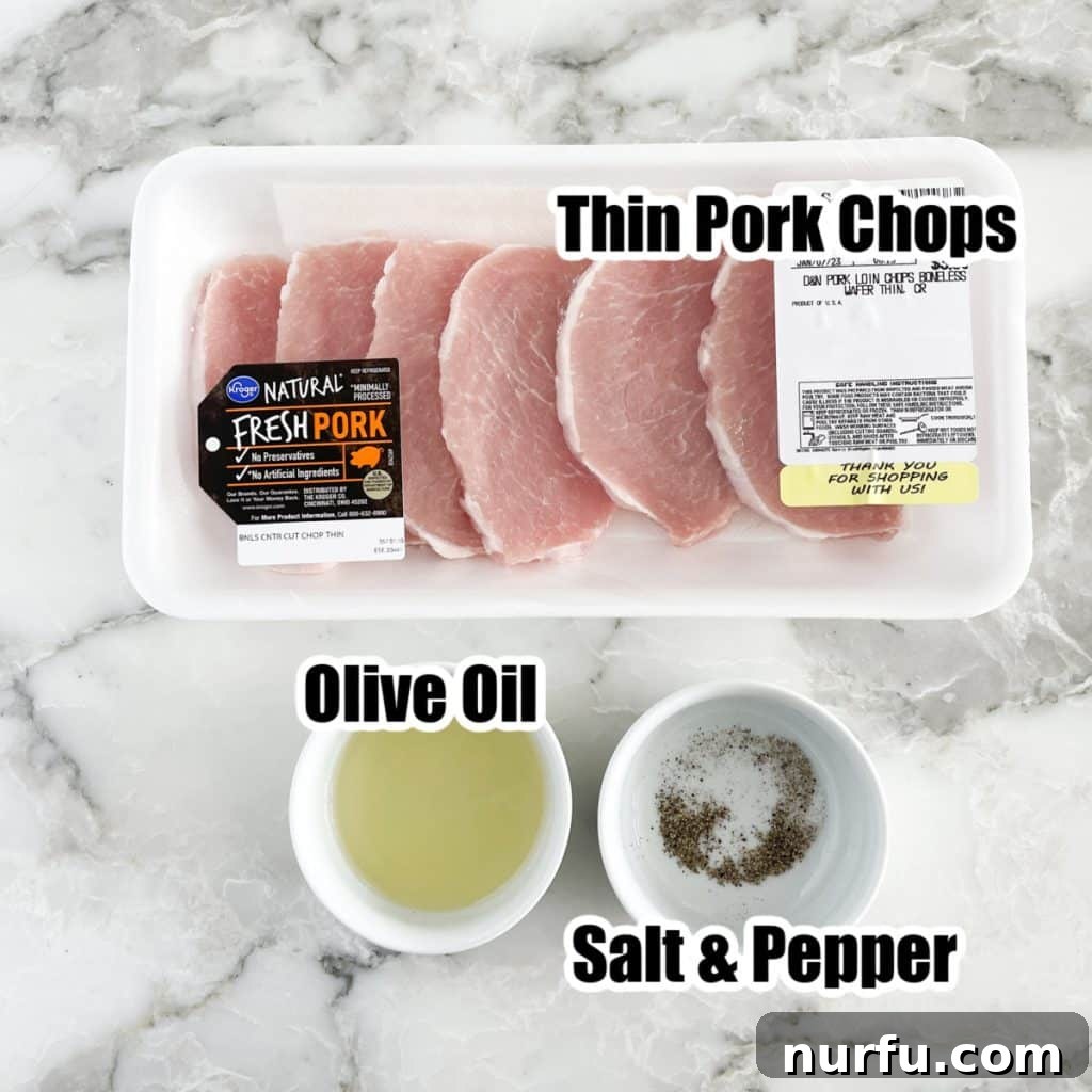 A curated selection of raw thin pork chops, a small bowl of glistening olive oil, and a separate bowl containing salt and pepper, illustrating the essential, simple ingredients for this recipe.