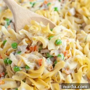 Wooden spoon in a noodle casserole.