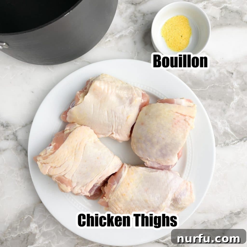 The Secret to Perfectly Tender Boiled Chicken Thighs 3 Plate of uncooked chicken thighs next to a small bowl of chicken bouillon granules.