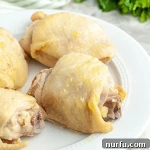 Boiled chicken thighs on a plate.