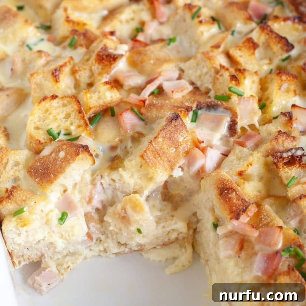 Brinner Bonanza: 31 Recipes for Anytime 5 A golden-baked Eggs Benedict Casserole, showing off its layers of English muffins, Canadian bacon, and eggs, ready to be topped with Hollandaise sauce.