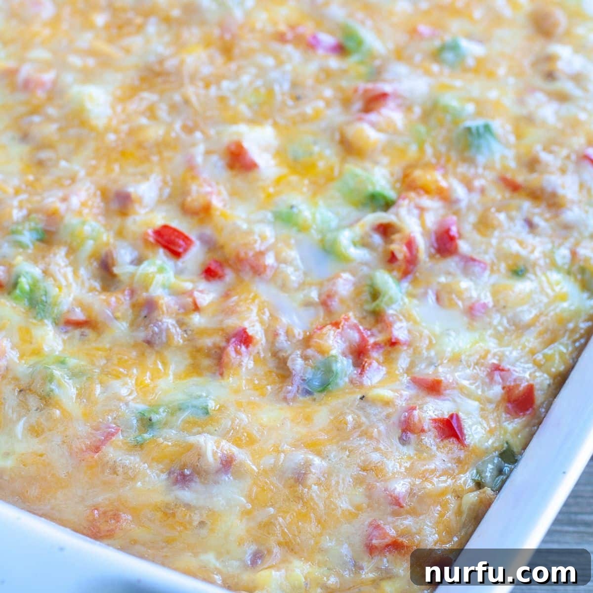 Brinner Bonanza: 31 Recipes for Anytime 8 A bubbling Farmer's Casserole fresh from the oven, showing its comforting layers of ham, hash browns, and cheesy eggs, perfect for a family meal.