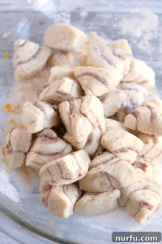 Orange rolls cut up in a bowl