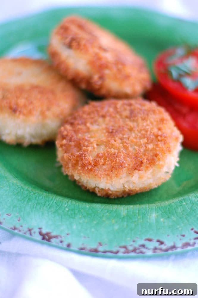 Golden Glazed Honey Garlic Turmeric Chicken 9 Crispy fried chicken croquettes, golden brown and perfectly cooked, served as a delightful snack or appetizer.