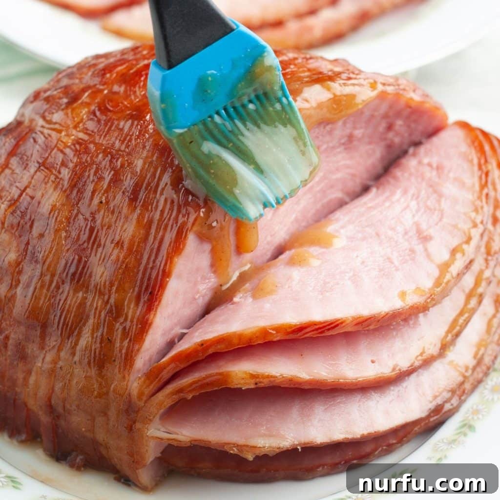 Tropical Pineapple Ham Glaze 6 A pastry brush applying the rich, glistening pineapple ham glaze generously over a baked ham, creating a beautiful, sticky coating.